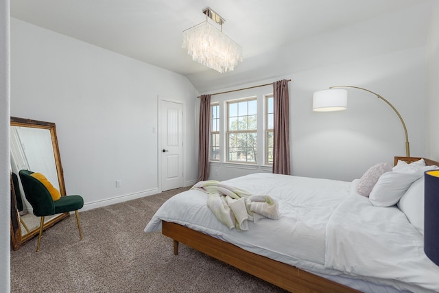 carpeted bedroom with lofted ceiling and a chandelier