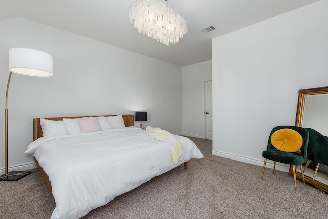 bedroom featuring a chandelier and carpet flooring