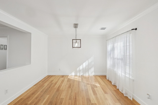 unfurnished dining area featuring ornamental molding and light wood-type flooring