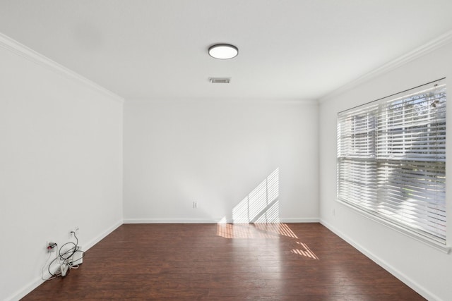 empty room featuring crown molding and dark hardwood / wood-style floors