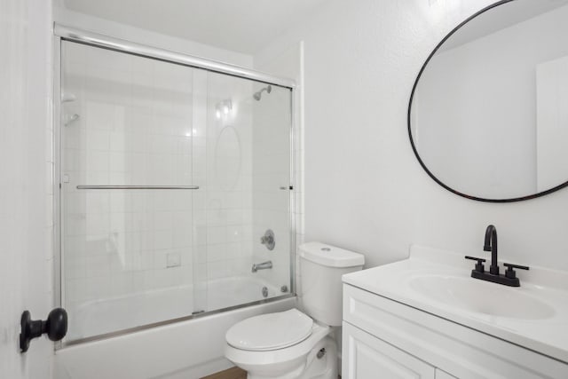 full bathroom with vanity, toilet, and combined bath / shower with glass door