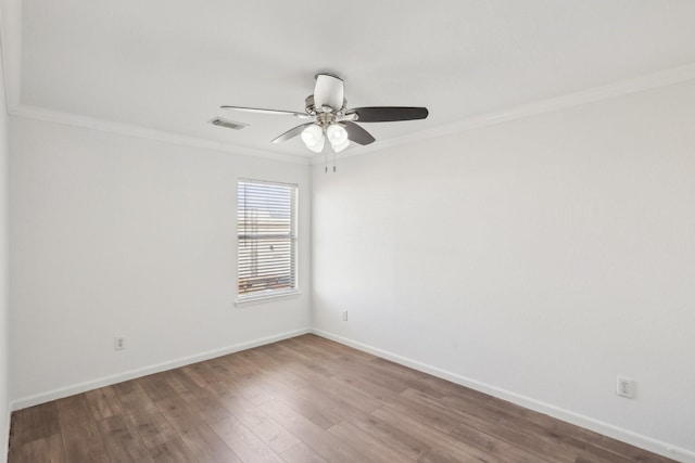 empty room with hardwood / wood-style floors, crown molding, and ceiling fan