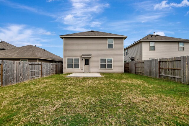 back of property with a patio area and a lawn