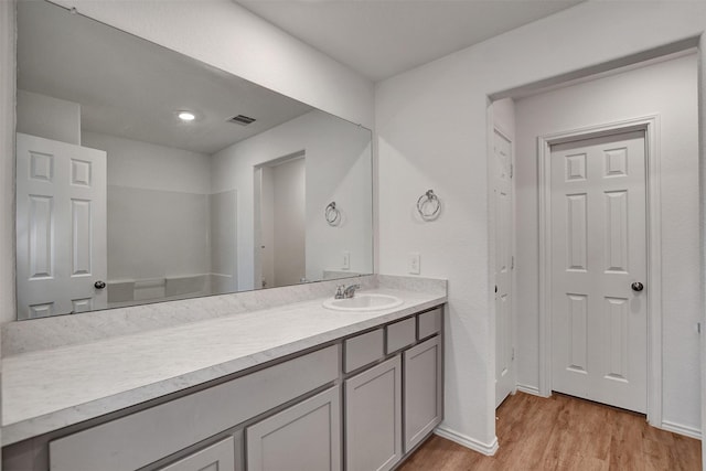 bathroom featuring hardwood / wood-style flooring and vanity