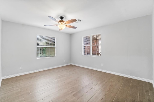 unfurnished room with ceiling fan and light wood-type flooring