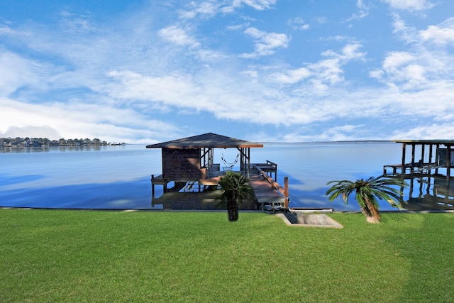 dock area with a water view and a lawn