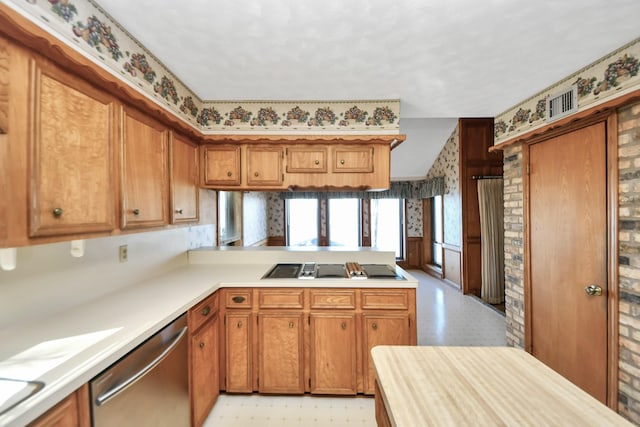 kitchen with stainless steel dishwasher, black electric stovetop, and kitchen peninsula