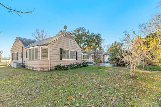 302 E Jackson St, West Columbia, TX 77486 - view of home's exterior with a yard and central AC unit