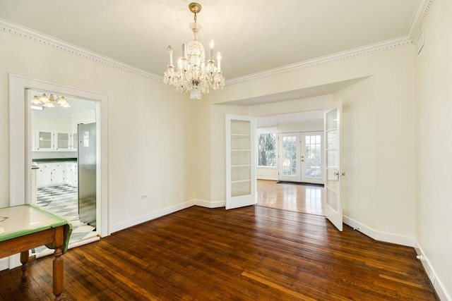 302 E Jackson St, West Columbia, TX 77486 - unfurnished dining area featuring crown molding, dark hardwood / wood-style floors, french doors, and an inviting chandelier