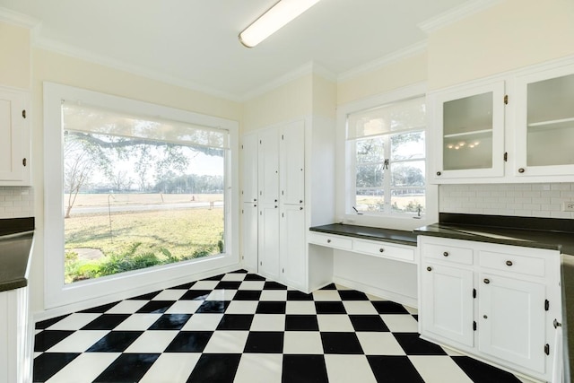 302 E Jackson St, West Columbia, TX 77486 - kitchen featuring tasteful backsplash, crown molding, and white cabinets