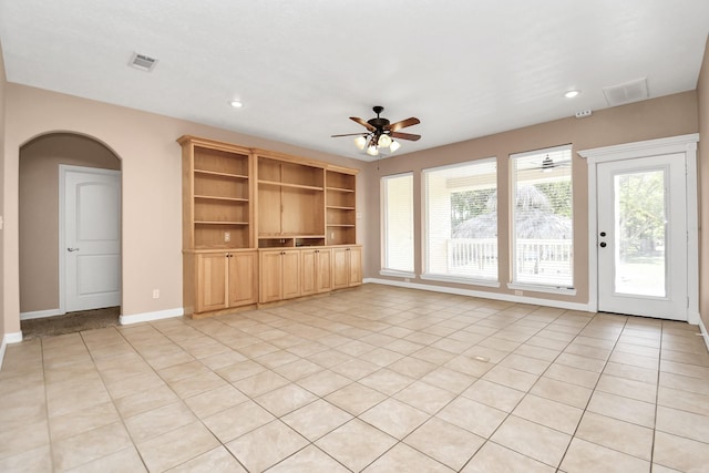 unfurnished living room with ceiling fan and light tile patterned floors