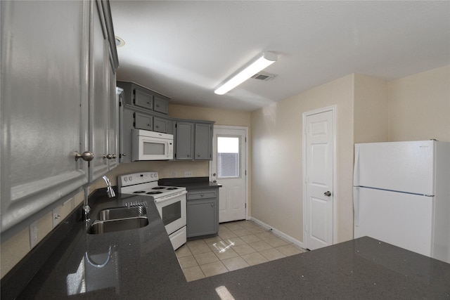 kitchen featuring gray cabinets, light tile patterned flooring, sink, and white appliances