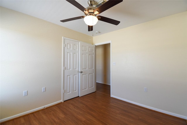 unfurnished bedroom featuring ceiling fan and dark hardwood / wood-style floors