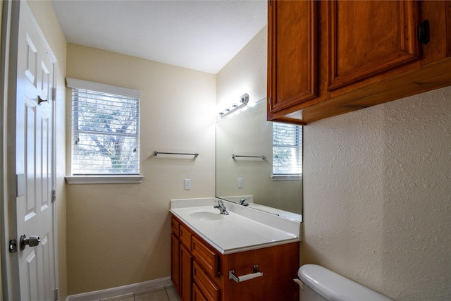 bathroom with vanity, tile patterned floors, and toilet