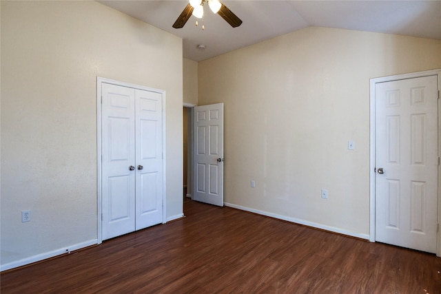 unfurnished bedroom featuring dark hardwood / wood-style flooring, vaulted ceiling, and ceiling fan