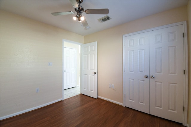 unfurnished bedroom with hardwood / wood-style flooring, a closet, and ceiling fan