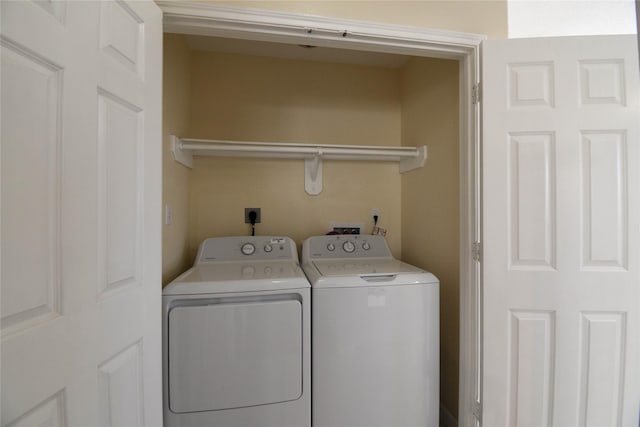 clothes washing area featuring washing machine and clothes dryer