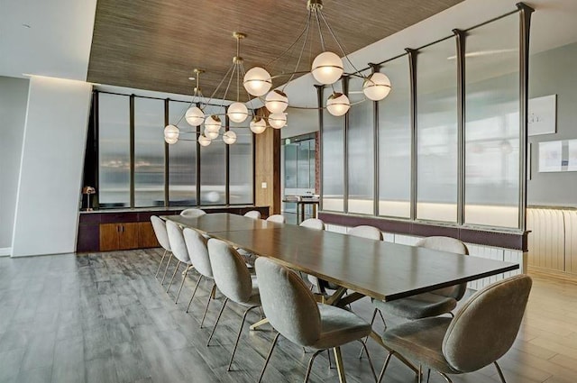 unfurnished dining area with a notable chandelier, light hardwood / wood-style flooring, wooden ceiling, and radiator heating unit