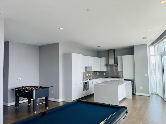 game room with pool table, sink, and light hardwood / wood-style flooring