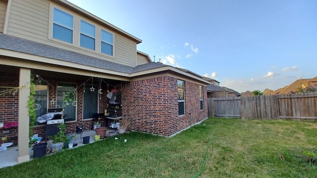 view of property exterior featuring a yard and a patio