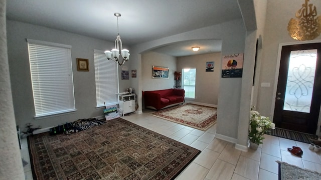 tiled foyer entrance with a notable chandelier