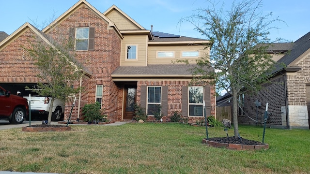 view of front of property with a garage, a front yard, and solar panels