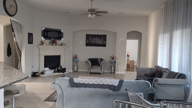 living room with ceiling fan and a healthy amount of sunlight