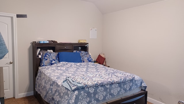 bedroom with lofted ceiling and carpet