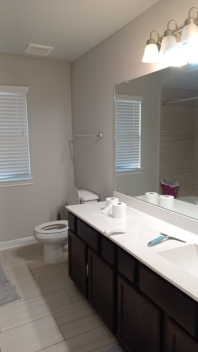 bathroom featuring vanity and toilet