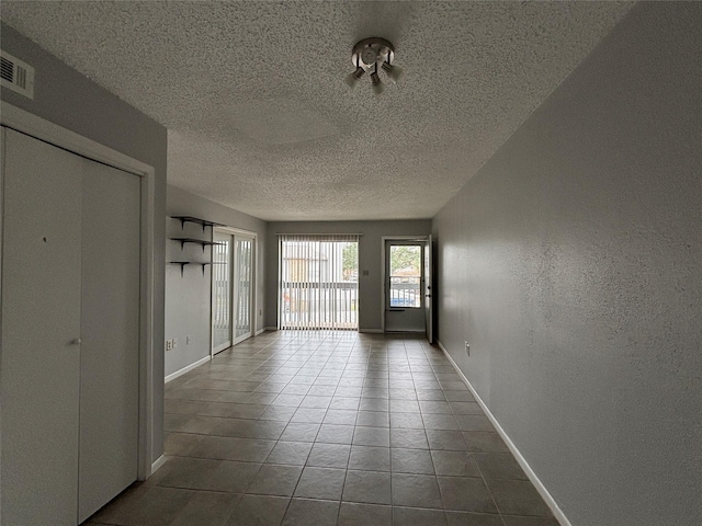 doorway to outside featuring a textured ceiling