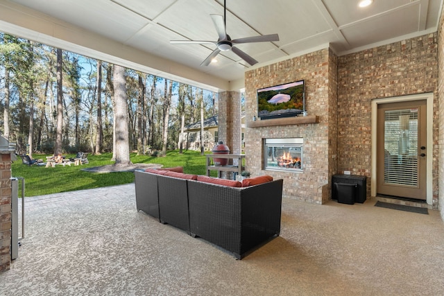 view of patio / terrace with an outdoor living space with a fireplace and ceiling fan