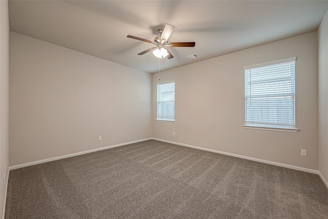 carpeted spare room featuring ceiling fan