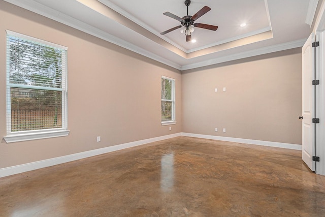 unfurnished room with crown molding, a tray ceiling, concrete floors, and ceiling fan