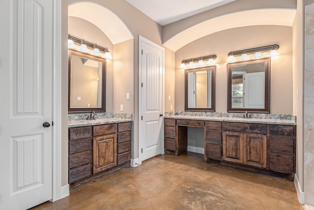 bathroom with vanity and concrete flooring