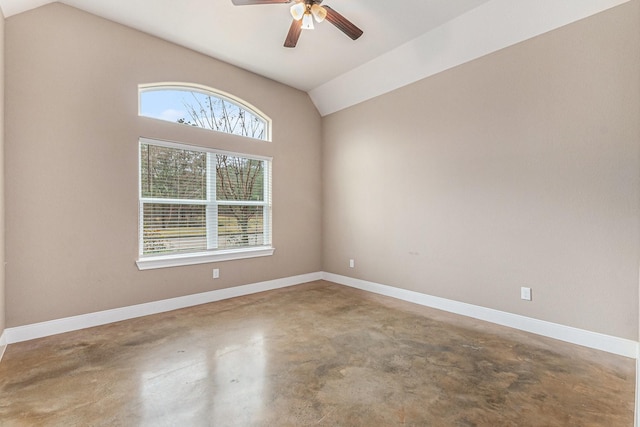 spare room with lofted ceiling, concrete floors, and ceiling fan