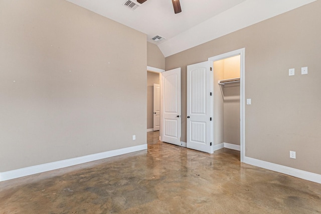 unfurnished bedroom featuring ceiling fan, concrete flooring, and vaulted ceiling