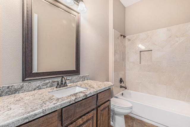 full bathroom with vanity, toilet, and tiled shower / bath combo