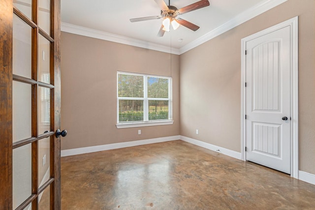 spare room featuring crown molding, concrete floors, and ceiling fan