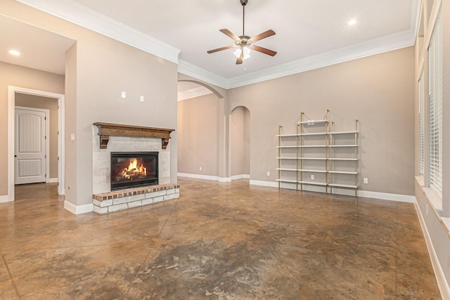 unfurnished living room featuring crown molding, ceiling fan, and a fireplace