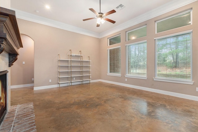 unfurnished living room featuring a brick fireplace, crown molding, concrete flooring, and ceiling fan