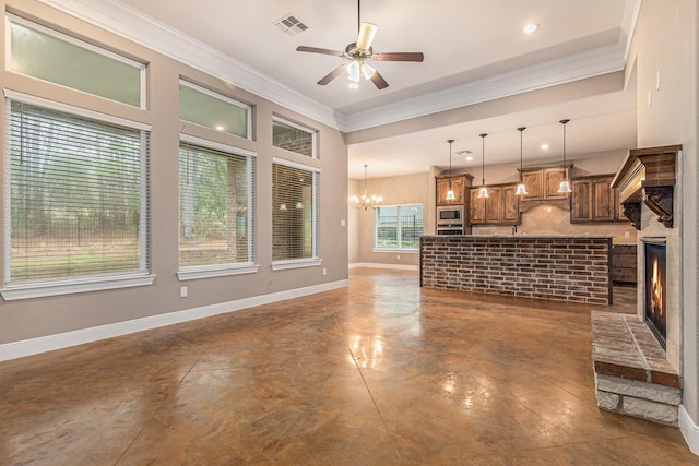 unfurnished living room with ornamental molding and ceiling fan with notable chandelier