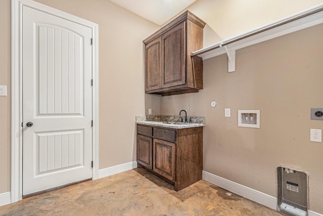 washroom with sink, hookup for a washing machine, cabinets, and hookup for an electric dryer