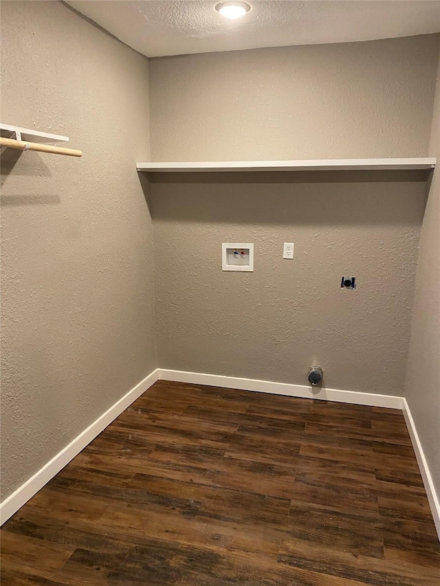 clothes washing area with hookup for a washing machine, electric dryer hookup, a textured ceiling, and dark hardwood / wood-style flooring