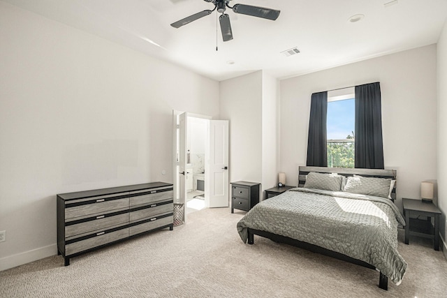 carpeted bedroom with connected bathroom and ceiling fan