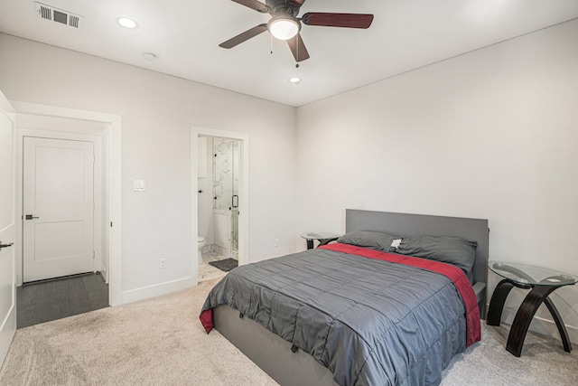 carpeted bedroom with connected bathroom and ceiling fan