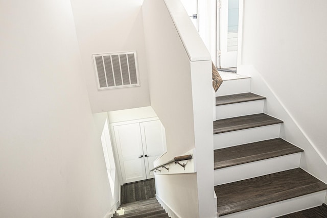 stairway featuring wood-type flooring