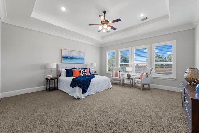 carpeted bedroom featuring a raised ceiling, crown molding, and ceiling fan