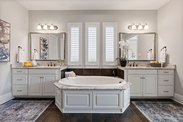 bathroom featuring tile patterned floors, vanity, and a tub