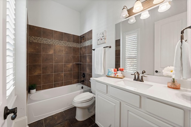 full bathroom featuring vanity, toilet, and tiled shower / bath