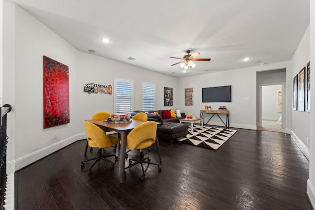 dining room with dark hardwood / wood-style flooring and ceiling fan